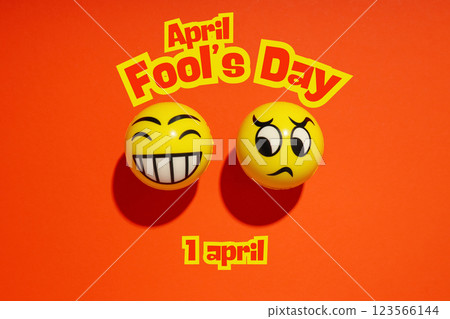 April Fool's Day, yellow emoji on a red background with text, top view April Fool's Day, yellow emoji on a red background with text, top view 123566144