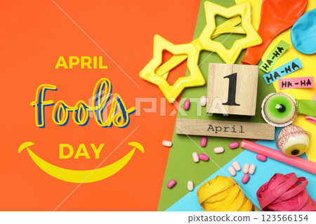 April Fool's Day, April 1st date on wooden cube and party decor on bright background, top view 123566154