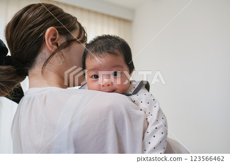 Baby hugged by mother 123566462