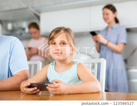 Portrait of children and parents using phones at home 123566527