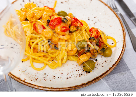 Pasta macaroni with seafood contains tiger prawns, shell mussels, spices and white sauce Pasta macaroni with seafood contains tiger prawns, shell mussels, spices and white sauce 123566529