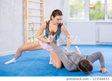 Woman and man practicing self defense techniques Woman and man practicing self defense techniques 123566633