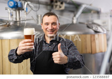 Cheerful man brewer with glass of beer 123566697