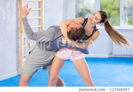 Woman and man practicing self defense techniques 123566857