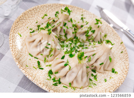 There is portion of khinkali on plate - national Georgian dish made of dough and meat There is portion of khinkali on plate - national Georgian dish made of dough and meat 123566859