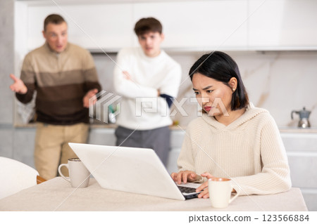 Guy and man quarrel with young woman with laptop 123566884