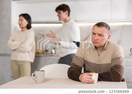 Adult man sad during family quarrel 123566889