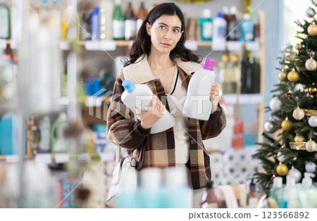 On New Year Eve, girl choose and buy liquid washing powder big capacity On New Year Eve, girl choose and buy liquid washing powder big capacity 123566892