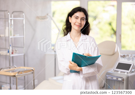 doctor meticulously stands in her clinic doctor meticulously stands in her clinic 123567300