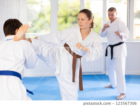 Man and woman train to perform basic defensive attacking actions during mortal techniques classes Man and woman train to perform basic defensive attacking actions during mortal techniques classes 123567306