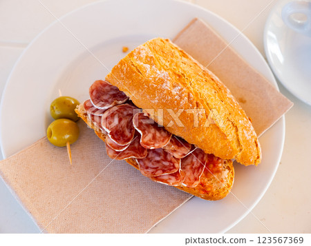 Sandwich with fuet sausage and olives. Spanish breakfast 123567369