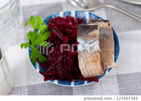 Sliced marinated herring with boiled grated beetroot and greens Sliced marinated herring with boiled grated beetroot and greens 123567393