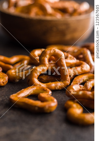 Heart shaped pretzel on black table. 123567685