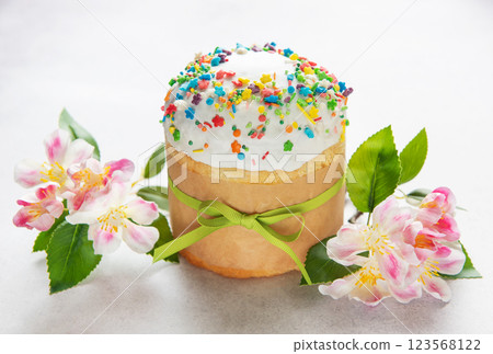 Delicious easter cake decorated with colorful sprinkles and tied with green ribbon Delicious easter cake decorated with colorful sprinkles and tied with green ribbon 123568122