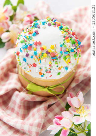 Delicious easter cake decorated with colorful sprinkles and spring flowers 123568123