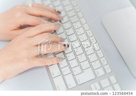 Woman with nails using a computer (work, gel nails, fashion designer) 123568454