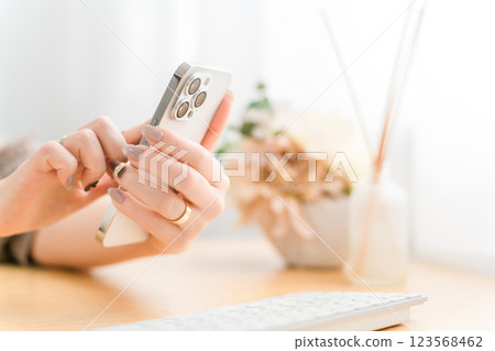 A woman with nails touching a smartphone screen 123568462