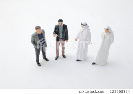 Miniature Figurines Meeting In Business Attire and Traditional Dress Miniature Figurines Meeting In Business Attire and Traditional Dress 123568554