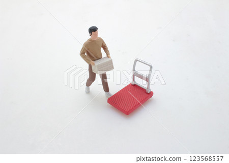 Miniature Model Worker Carrying Box with Red Hand Truck 123568557