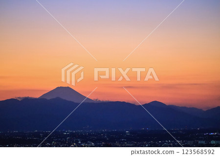 Urban City Lights at Dusk with Mountains Tokyo Dec 4 2024 123568592