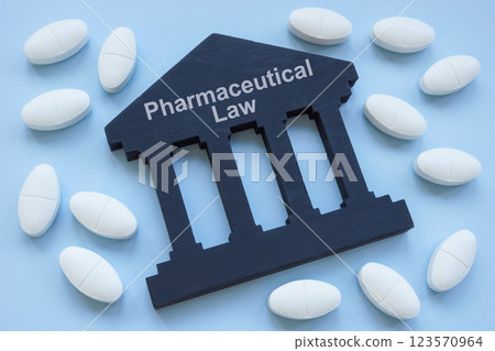 Pills and the sign pharmaceutical law. Represents drug regulations concept. Pills and the sign pharmaceutical law. Represents drug regulations concept. 123570964