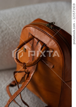 photo of a brown leather backpack with retro look. indoors photo 123571919