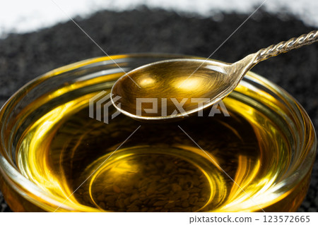Unrefined cold pressed sesame oil in a glass bowl. Unrefined cold pressed sesame oil in a glass bowl. 123572665