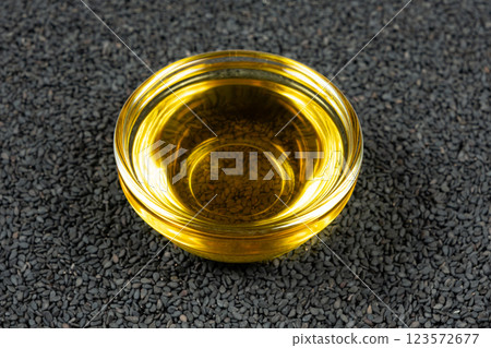 Unrefined cold pressed sesame oil in a glass bowl. 123572677