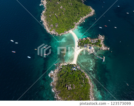 Lush green islands connected by a sandy beach surrounded by turquoise waters under sunny skies. Ko Nang Yuan, Thailand. Lush green islands connected by a sandy beach surrounded by turquoise waters under sunny skies. Ko Nang Yuan, Thailand. 123573099
