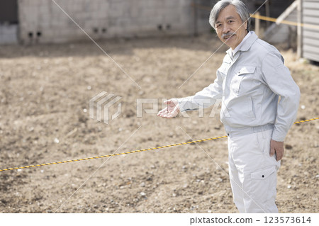 Man in work clothes with land 123573614