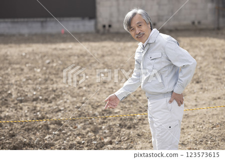 Man in work clothes with land 123573615