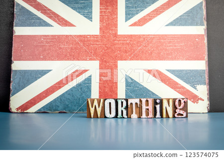 WORTHING. Urban Area in Great Britain. Flag and alphabet letters on wooden texture background WORTHING. Urban Area in Great Britain. Flag and alphabet letters on wooden texture background 123574075