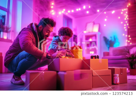 Father and son sharing quality time while packing food supplies in a cozy living room Father and son sharing quality time while packing food supplies in a cozy living room 123574213