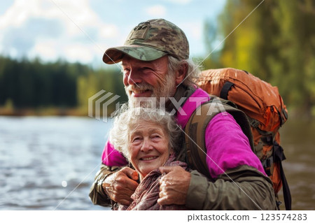 Man heroically carries elderly woman through floodwaters showing bravery and compassion Man heroically carries elderly woman through floodwaters showing bravery and compassion 123574283