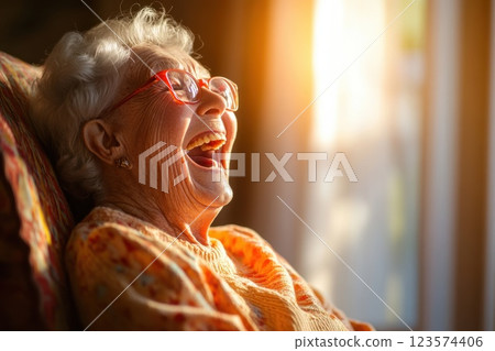 Elderly woman experiences pure joy with tears of laughter in a cozy room at sunset Elderly woman experiences pure joy with tears of laughter in a cozy room at sunset 123574406