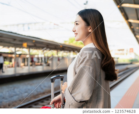 A woman with a gentle expression waiting for a train at the station 123574628