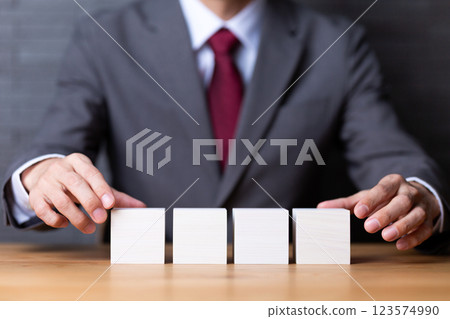 四塊白色木塊和穿著西裝的中年男性商人 123574990