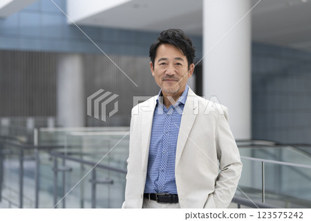 A man in his mid-50s smiling at the camera A man in his mid-50s smiling at the camera 123575242