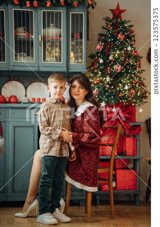 Beautiful mother and son at the Christmas tree.  123575375