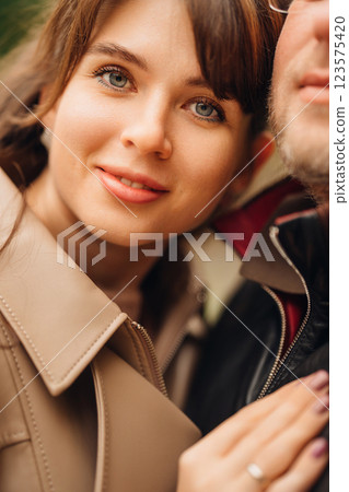 Couple enjoying an intimate moment outdoors during a sunny day Couple enjoying an intimate moment outdoors during a sunny day 123575420