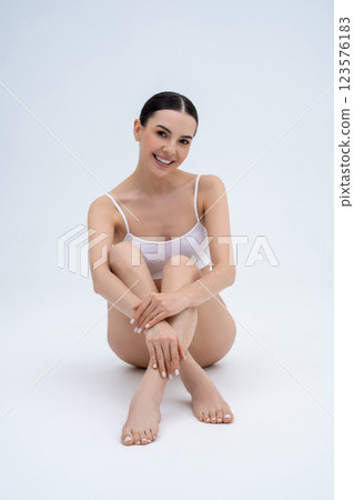 Smiling pretty caucasian woman in white lingerie looking happy and relaxed Smiling pretty caucasian woman in white lingerie looking happy and relaxed 123576183