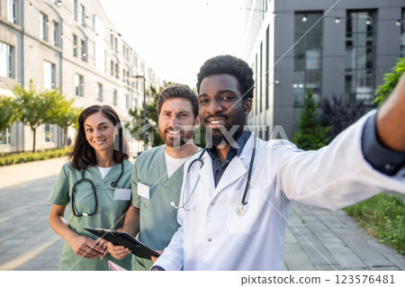 Group of doctors in lab coats looking positive and contented 123576481