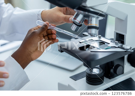 Teacher and a student working in a school scientific laboratory 123576786