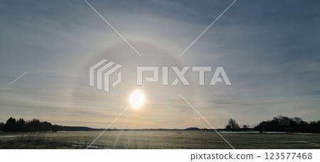 Amazing winter sun halo landscape Amazing winter sun halo landscape 123577468