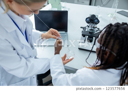 People working in a school laboratory and looking involved 123577656