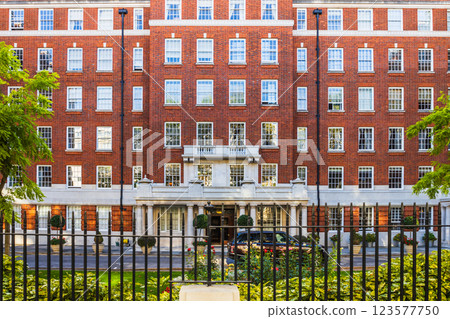 Red Brick Building Exterior with Classic Architecture and Iron Fence in a London Neighborhood 123577750