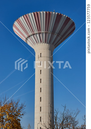 Tall concrete water tower 123577759