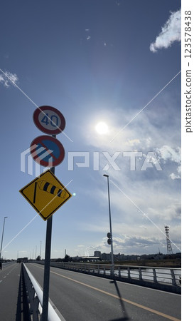 A road sign and a supplementary sign that says 123578438