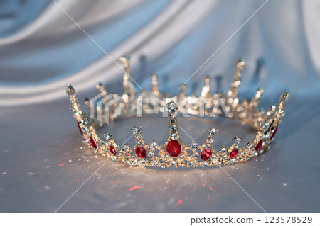 Sparkle royal golden crown with red gemstones 123578529