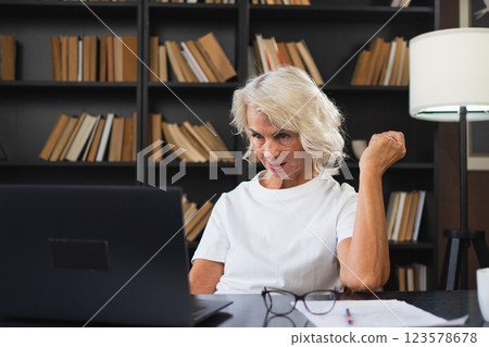 Video call. Happy middle aged senior woman sit with laptop talk on video call. Mature old senior lady having fun talking speaking online. Older generation modern tech usage Virtual meeting online chat 123578678